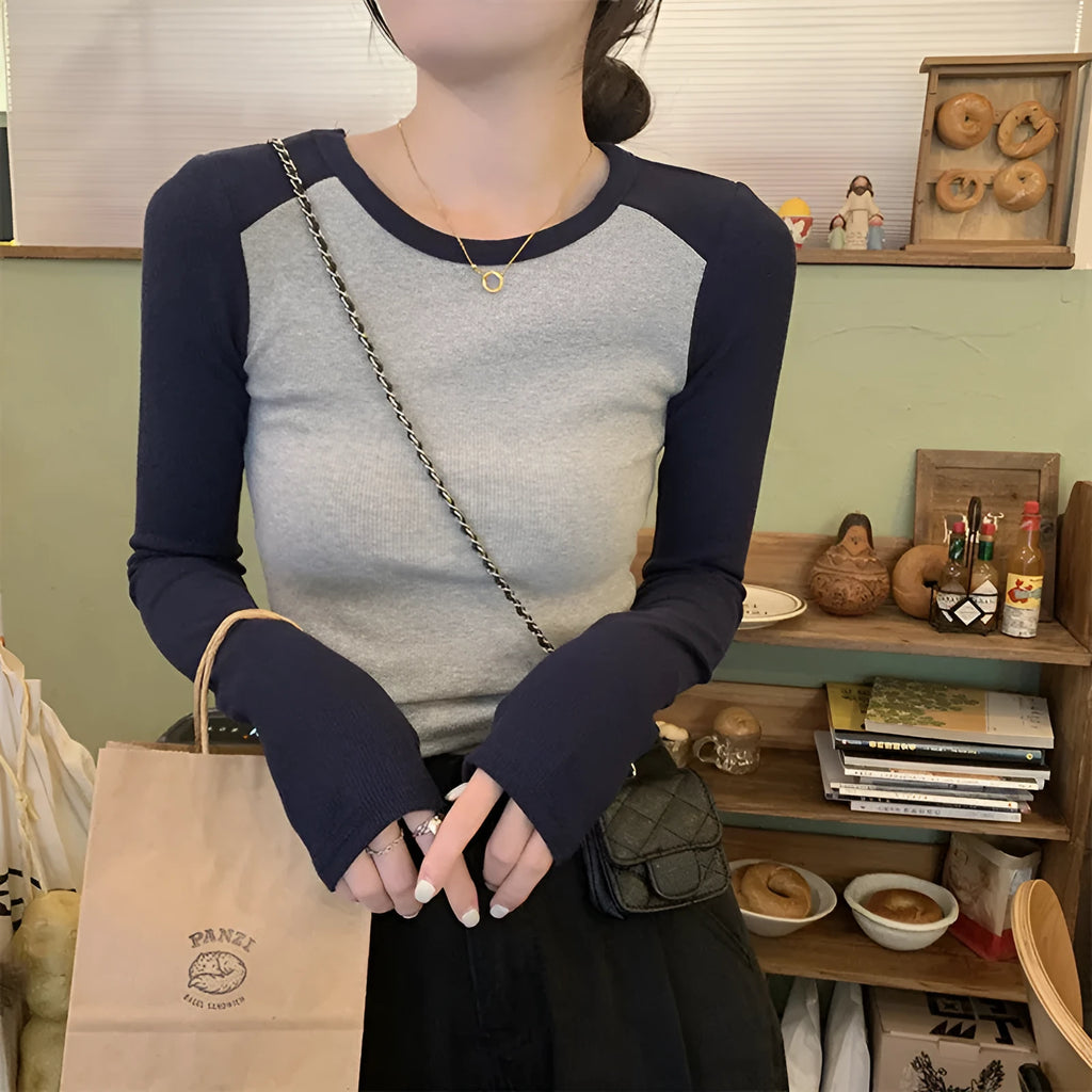 Women's dark blue slim-fit viscose top with long princess sleeves and embroidery detail on the front.