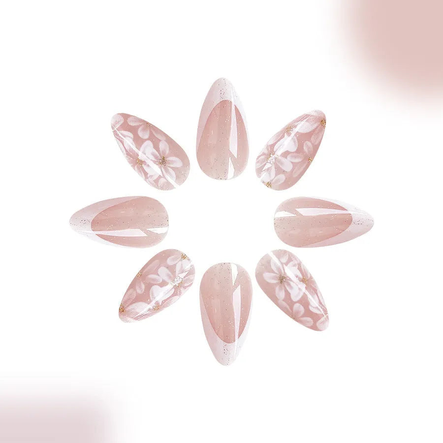Short glossy almond French style press-on nails with glittering powder flowers in colour C625