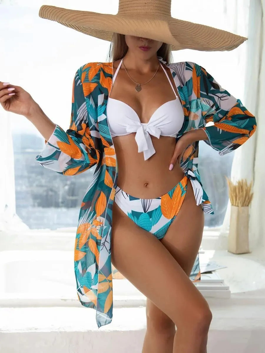 Women's three-piece polyester bikini swimsuit set with mesh split, showing top, pants, and coat.
