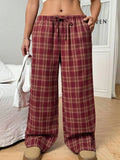 Blue plaid women's casual trousers with drawstring waist and pockets on a hanger.