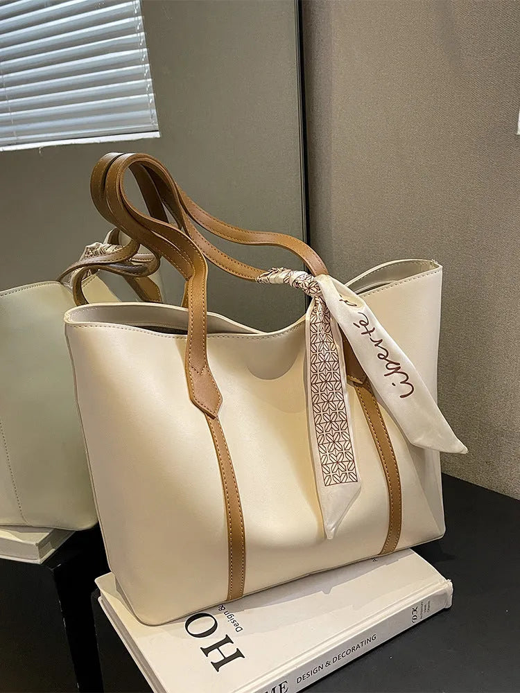 Soft large capacity tote bag with crossbody strap showing internal zipper compartment