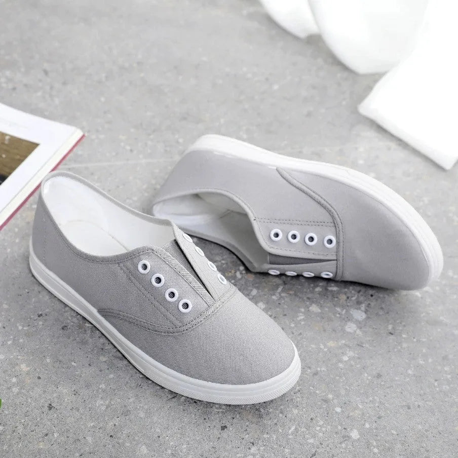 A pair of low-top canvas casual shoes in a choice of colours, featuring a flat heel and cloth lining.