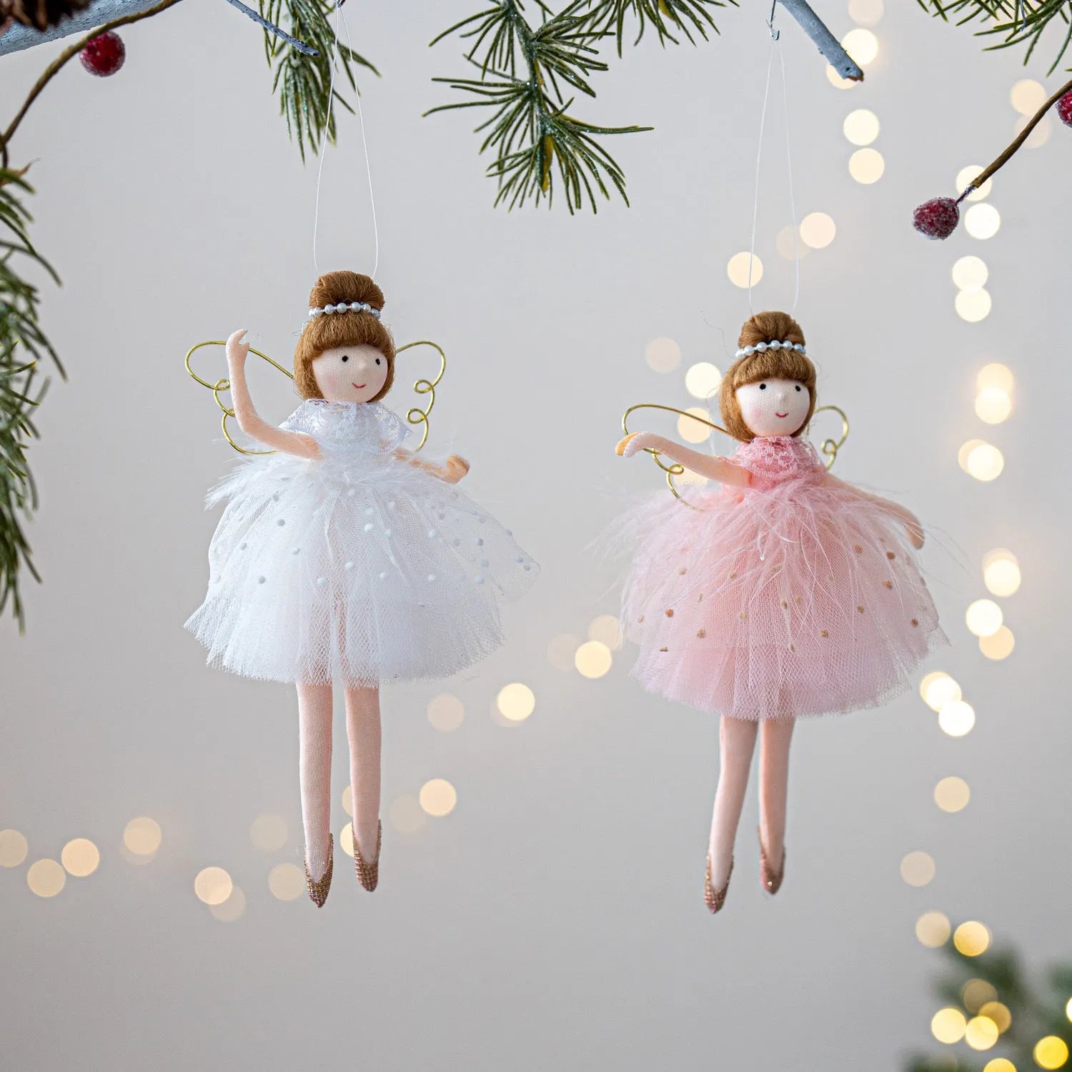 Pink and white cloth ballet girl angel plush doll pendant on a plain background.