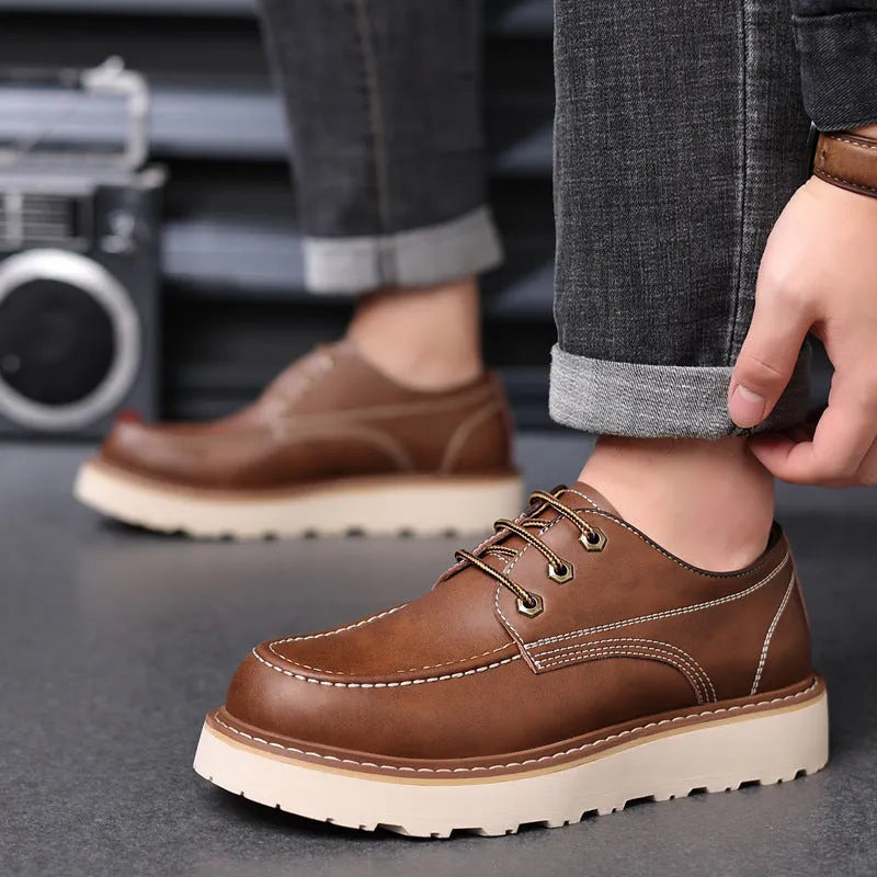Men's black retro low-top casual boots with round toe and rubber sole on a neutral background.