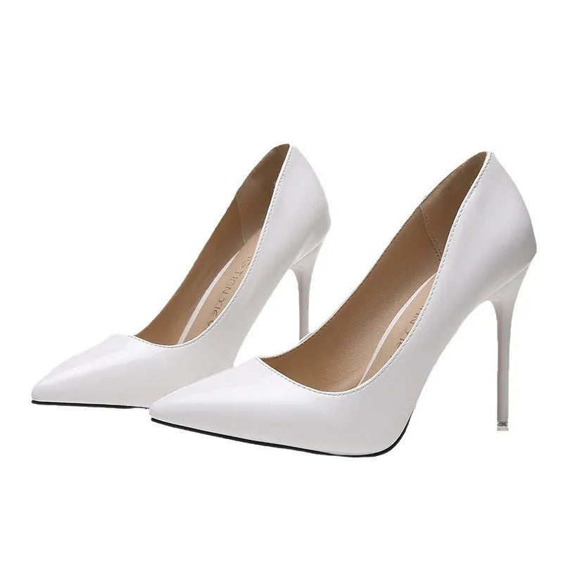 Women's nude apricot stiletto heel pointed toe pumps with buckle detail and rubber sole