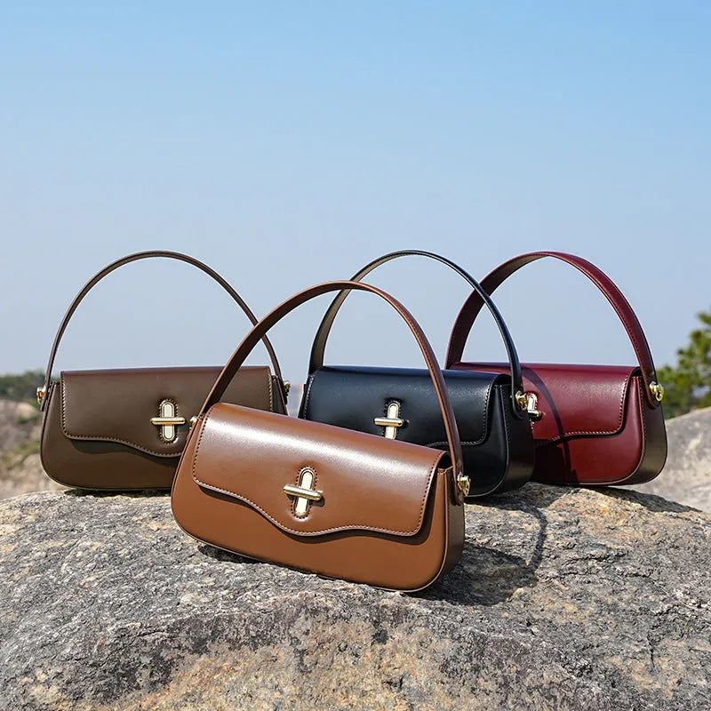 Genuine leather baguette handbag in caramel colour with clamshell design and shoulder straps
