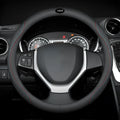 Black leather steering wheel cover with coloured stitching, shown fitted on a car wheel.