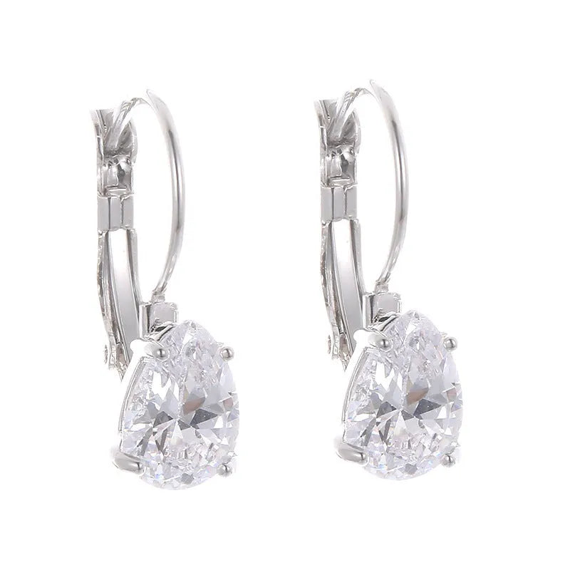Women's drop-shaped metal earrings in gold or platinum colour with inlaid gem details