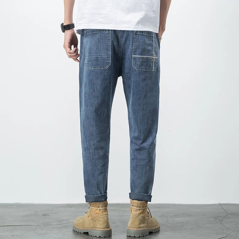 Men's loose plus size elastic waist jeans in blue cotton denim with mid waist straight leg fit