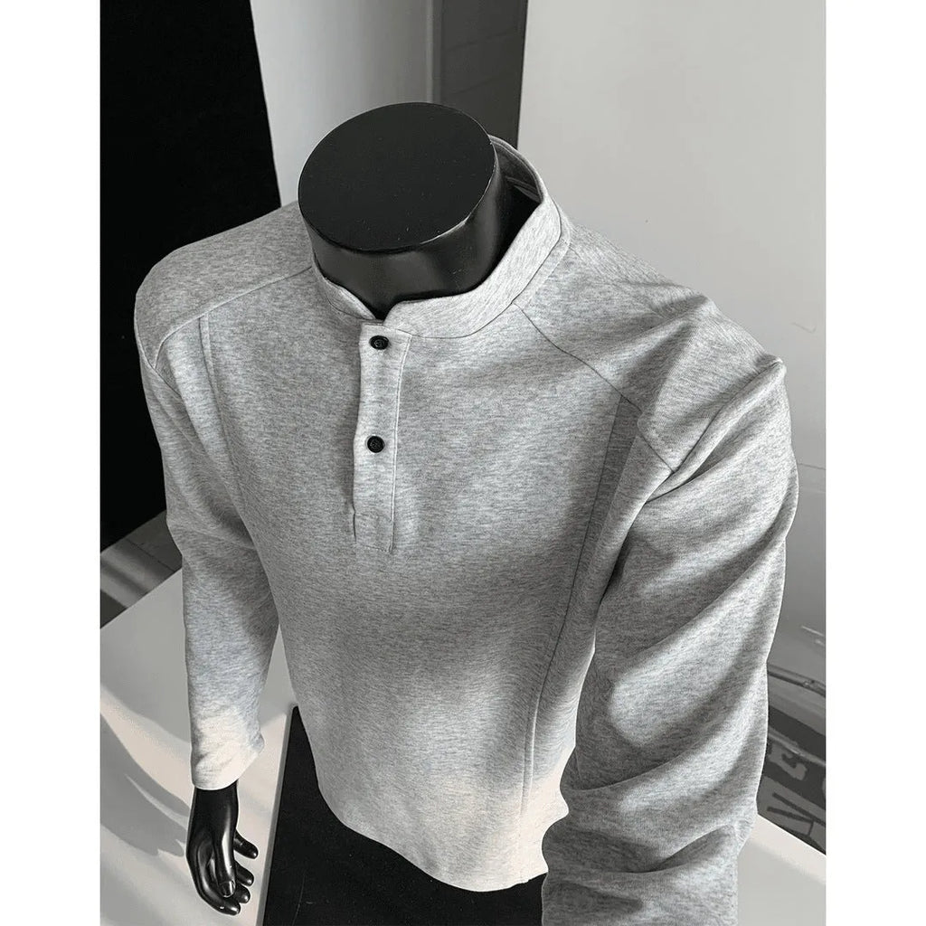 Men's loose-fitting asymmetric patchwork polo shirt with a stand-up collar and long sleeves in grey.