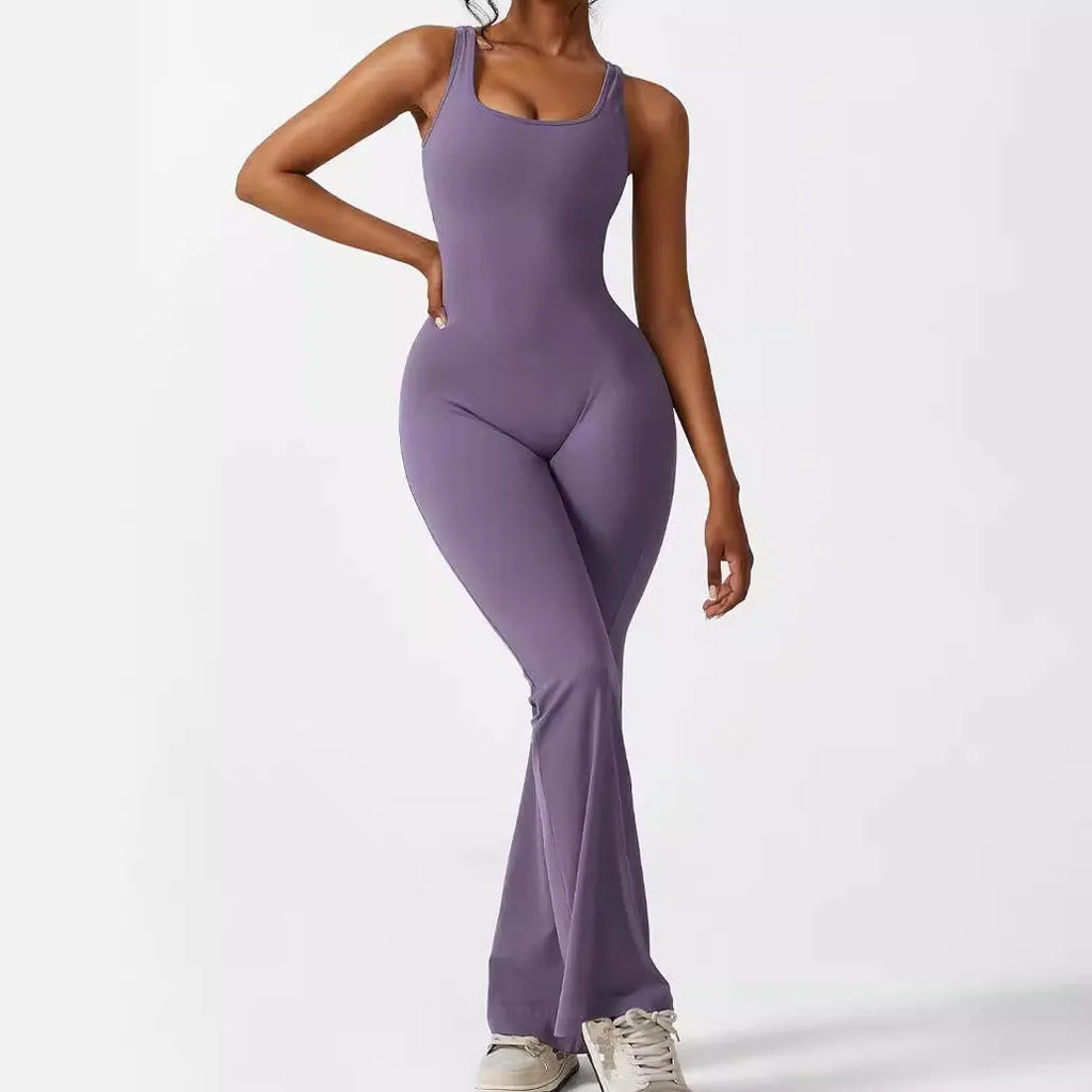 Woman wearing a sleeveless army green flare-leg jumpsuit for yoga fitness.