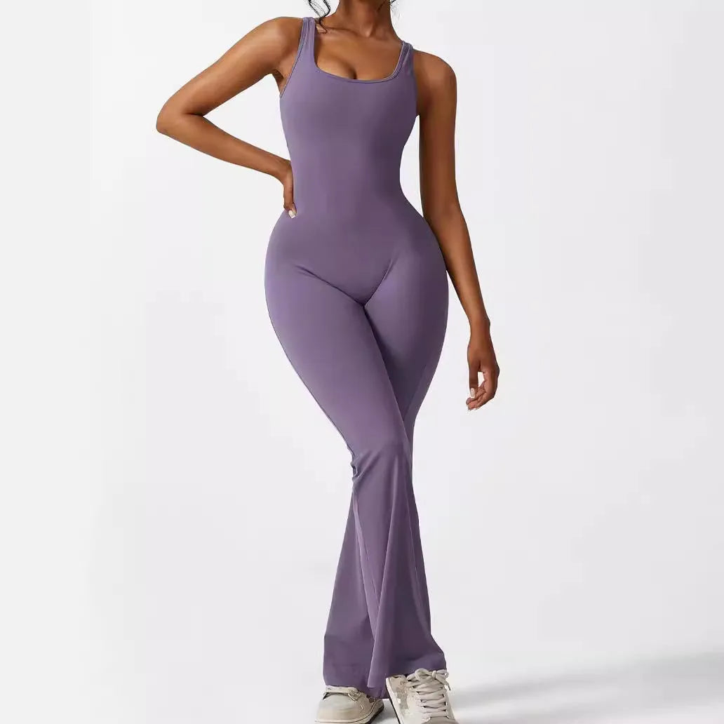 Woman wearing a sleeveless army green flare-leg jumpsuit for yoga fitness.