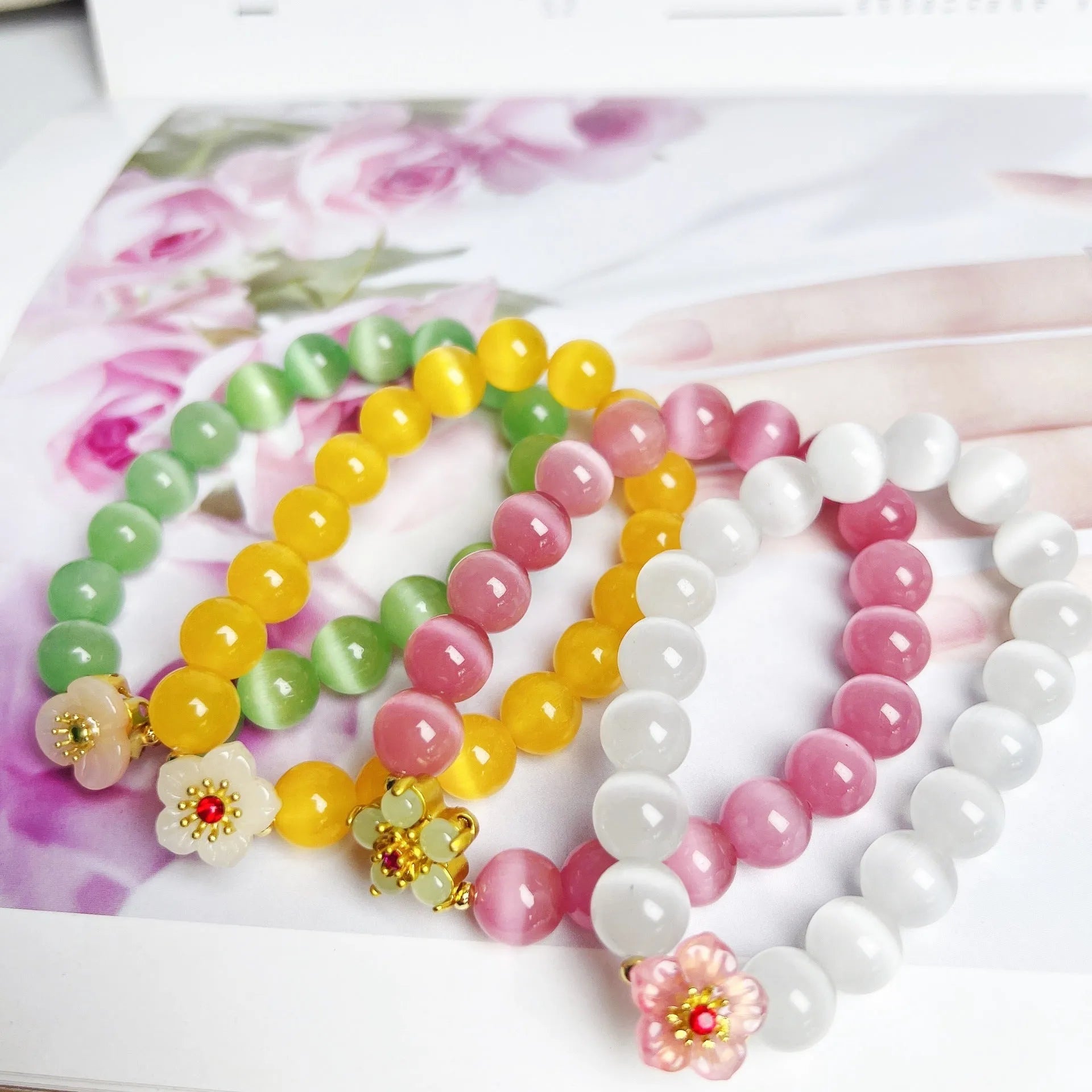 Handmade women's glass beaded bracelet with floral elements in yellow, pink, white, or green options