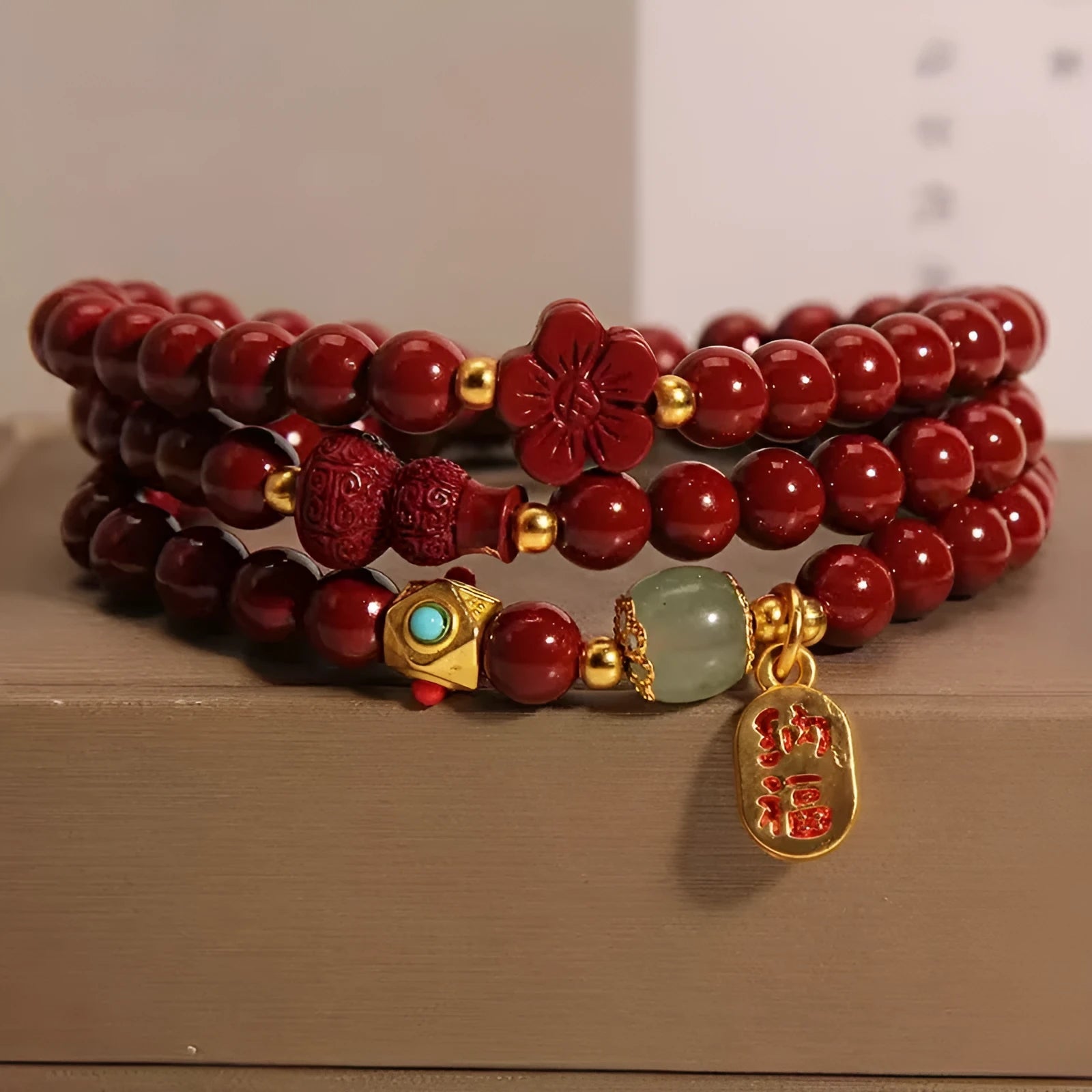 Red cinnabar bracelet with 6mm beads showing multi-circle gourd and five petal flower geometric design