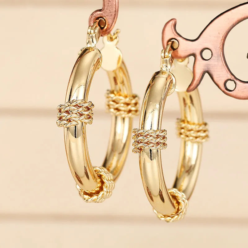 Geometric copper ring ear clip earrings in golden finish with linear design details