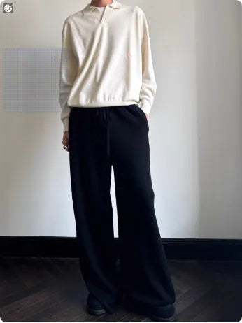Man wearing a milky white pure wool polo sweater with a lapel collar, showcasing its loose fit.