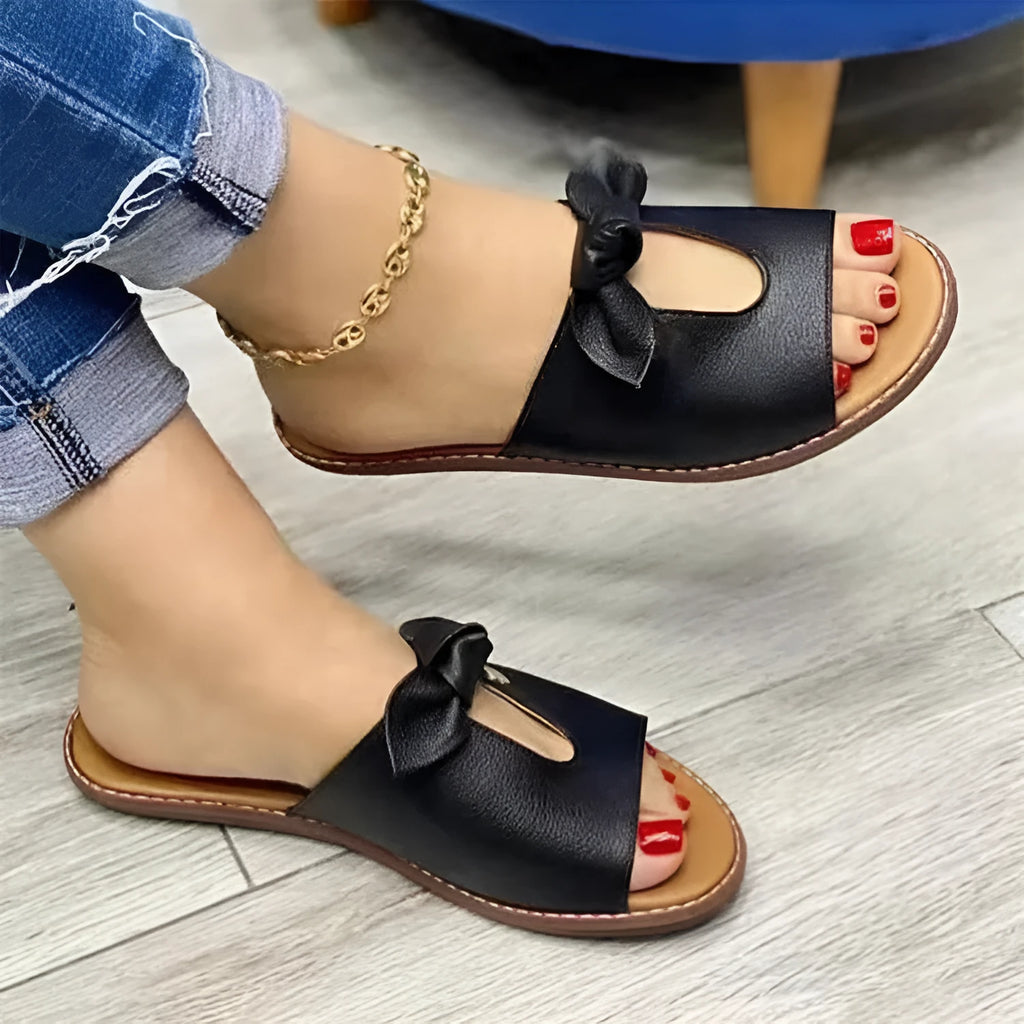 Ladies fish mouth sandals with decorative bow in black, gold, or pink on a rubber sole.