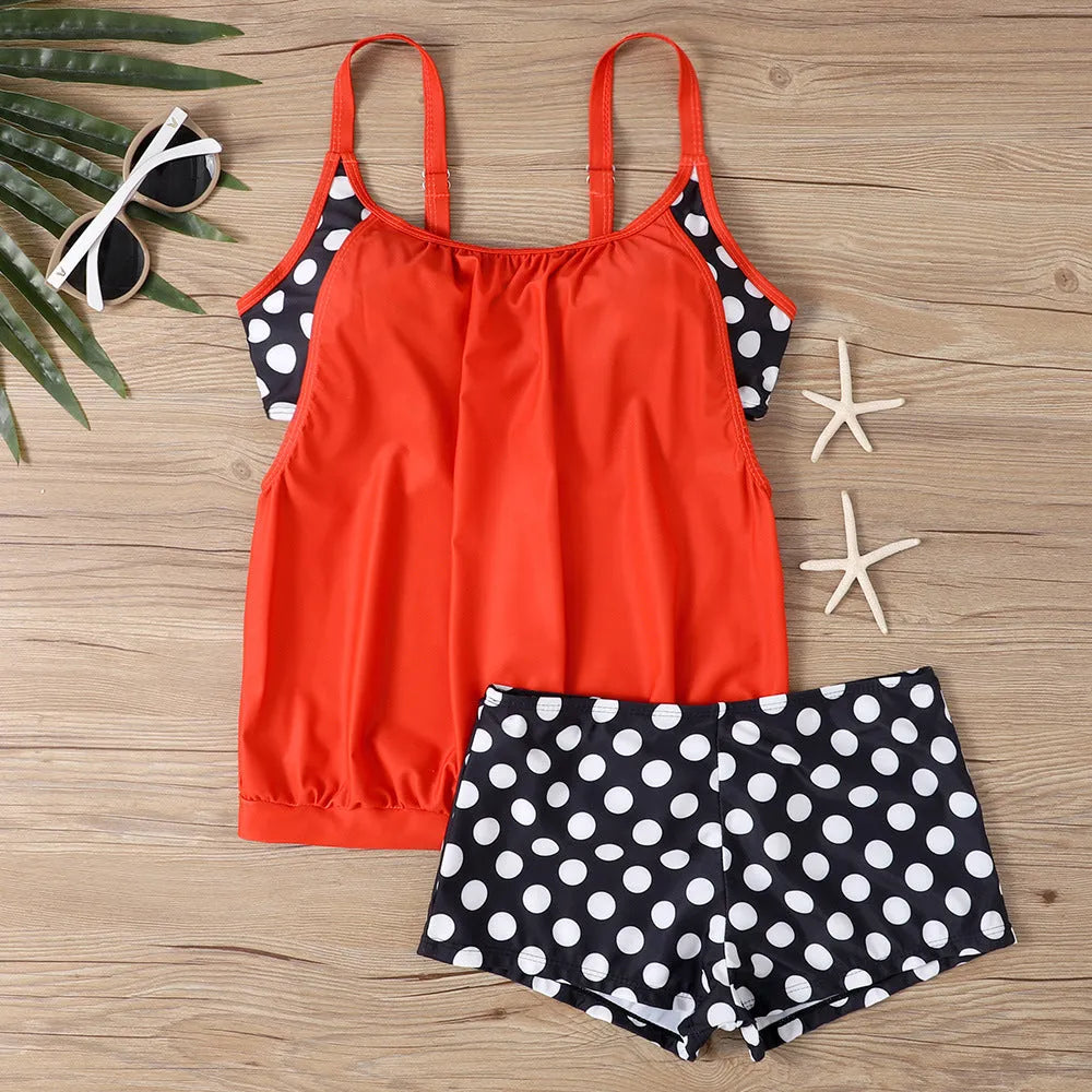 Women's black polka dot high-waisted boxer swimsuit set shown on a model.