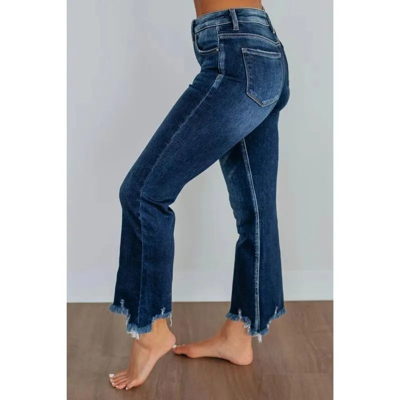 Women's dark blue denim casual trousers with a hand-distressed finish on a hanger.