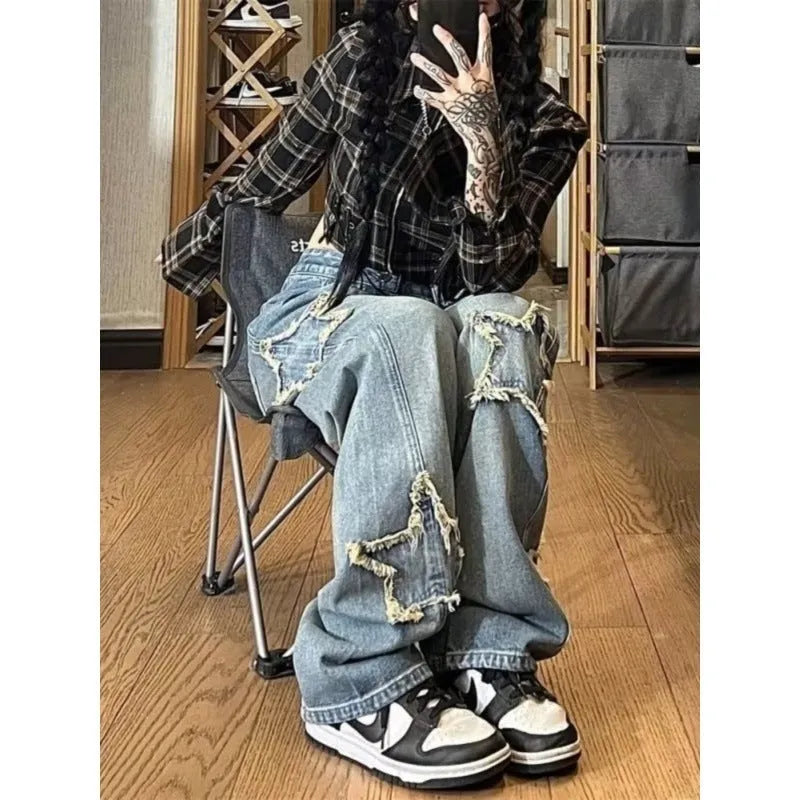 Blue high-waisted women's wide-leg denim trousers on a plain background