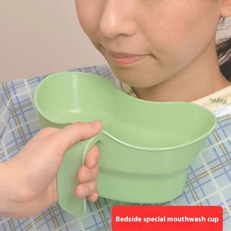 Green plastic bedridden patient gargle cup for nursing care and oral hygiene.