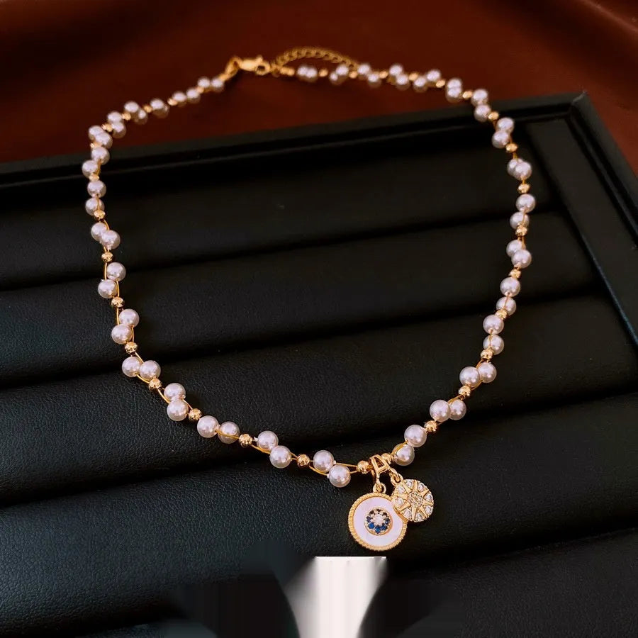 Gold plated clavicle necklace with round imitation pearl and zircon pendant on a 41-50cm chain.