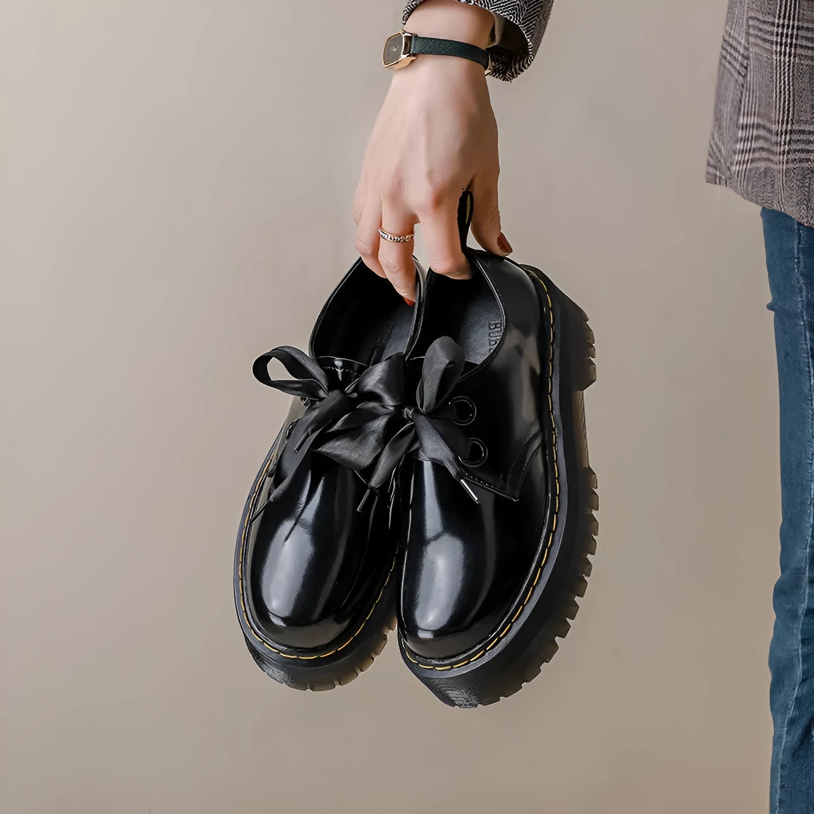 Women's black thick soled leather shoes with cross strap and ribbon lacing closure