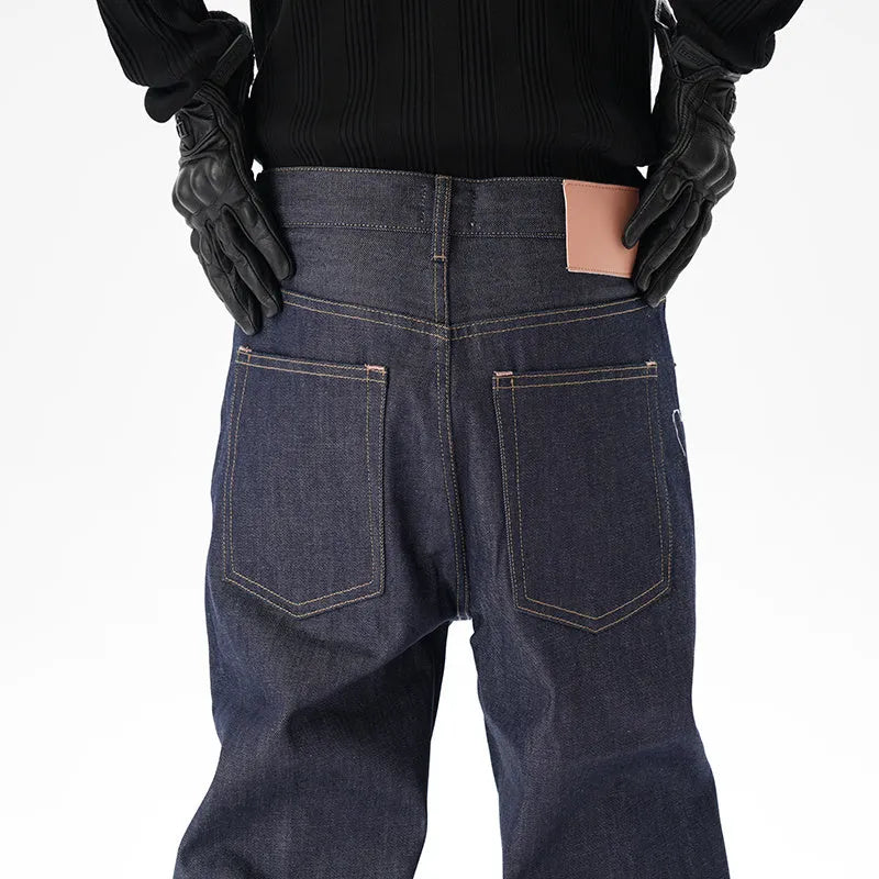 A pair of dark blue loose straight-cut jeans laid flat, showing the front design.