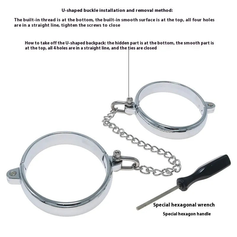 Silver zinc alloy metal handcuffs and footcuffs set for adult bondage play on a dark background.