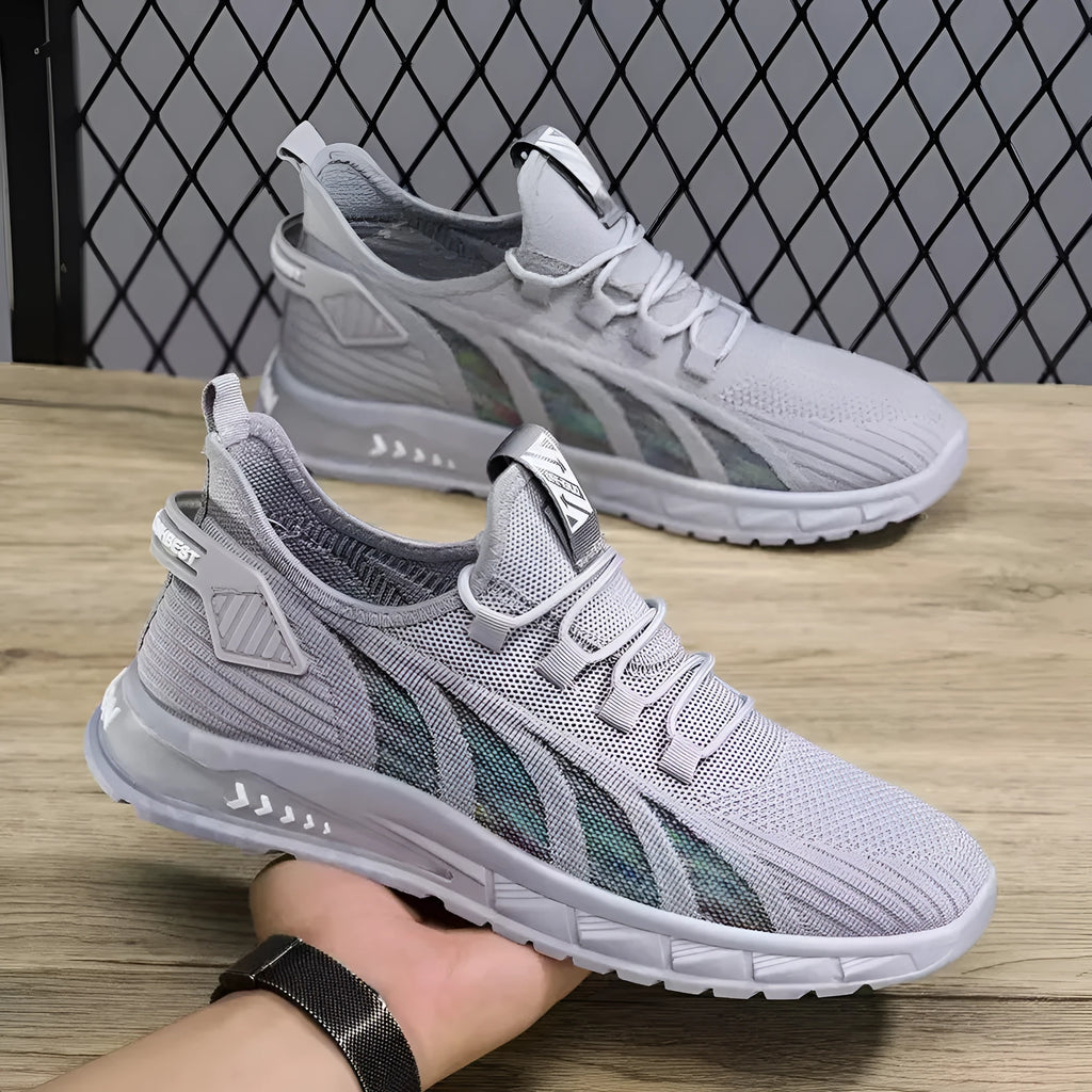 Low-top casual sneakers with mesh upper in colours black, grey, and beige on a flat plastic sole