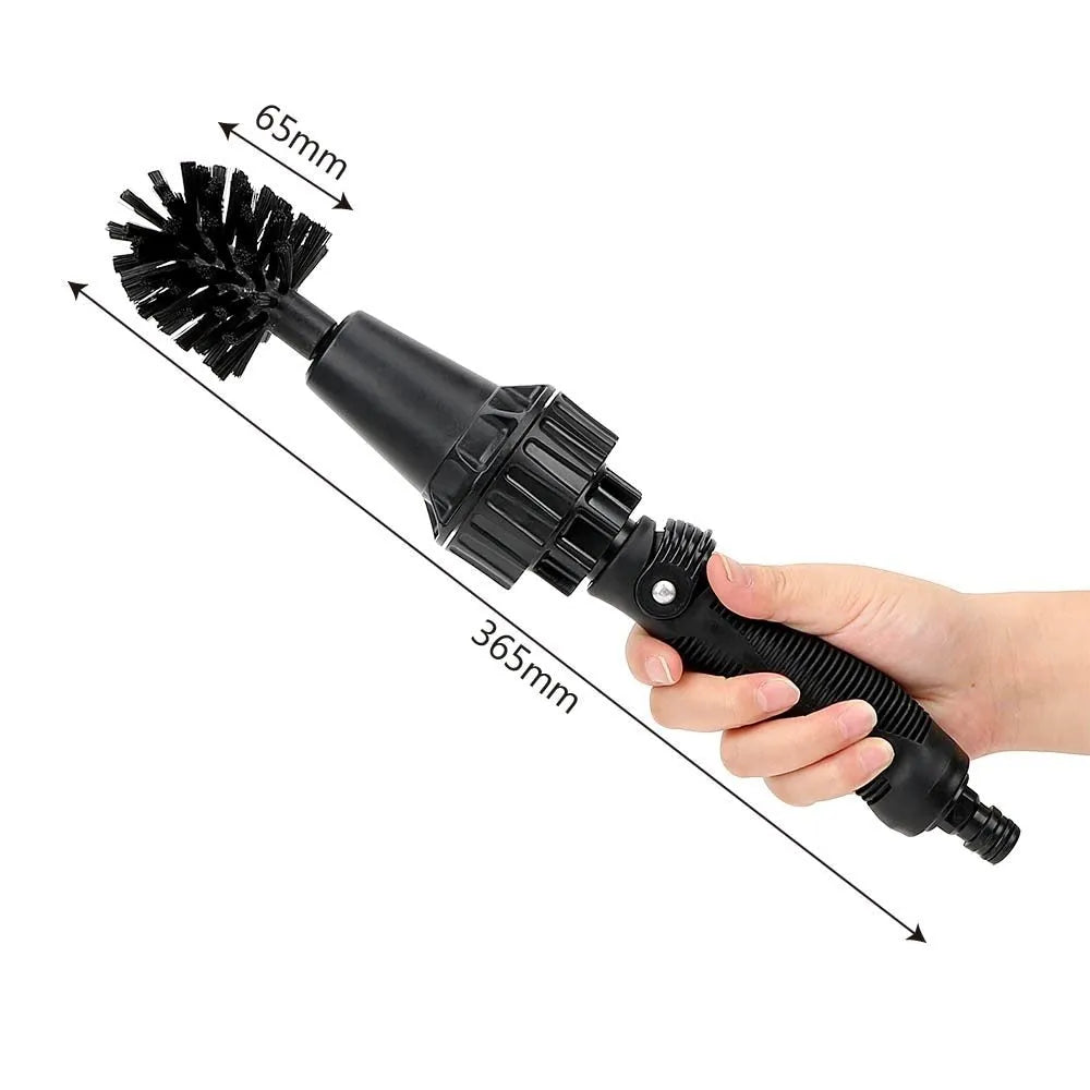 Water-driven rotary cleaning brush in black and yellow plastic connected to a garden hose for car wheel cleaning