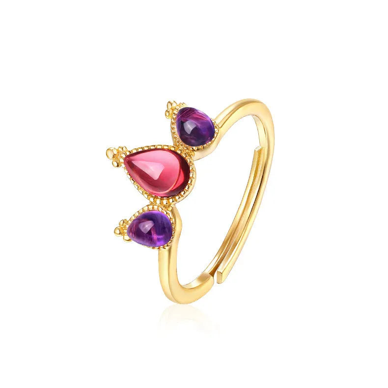 Sterling silver ring with drop-shaped garnet stone on finger, 925 silver, electroplated finish