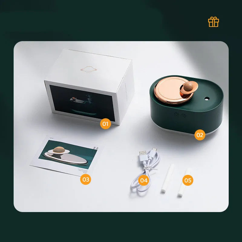 Green rotating planet-shaped USB humidifier with night light on a wooden desk.