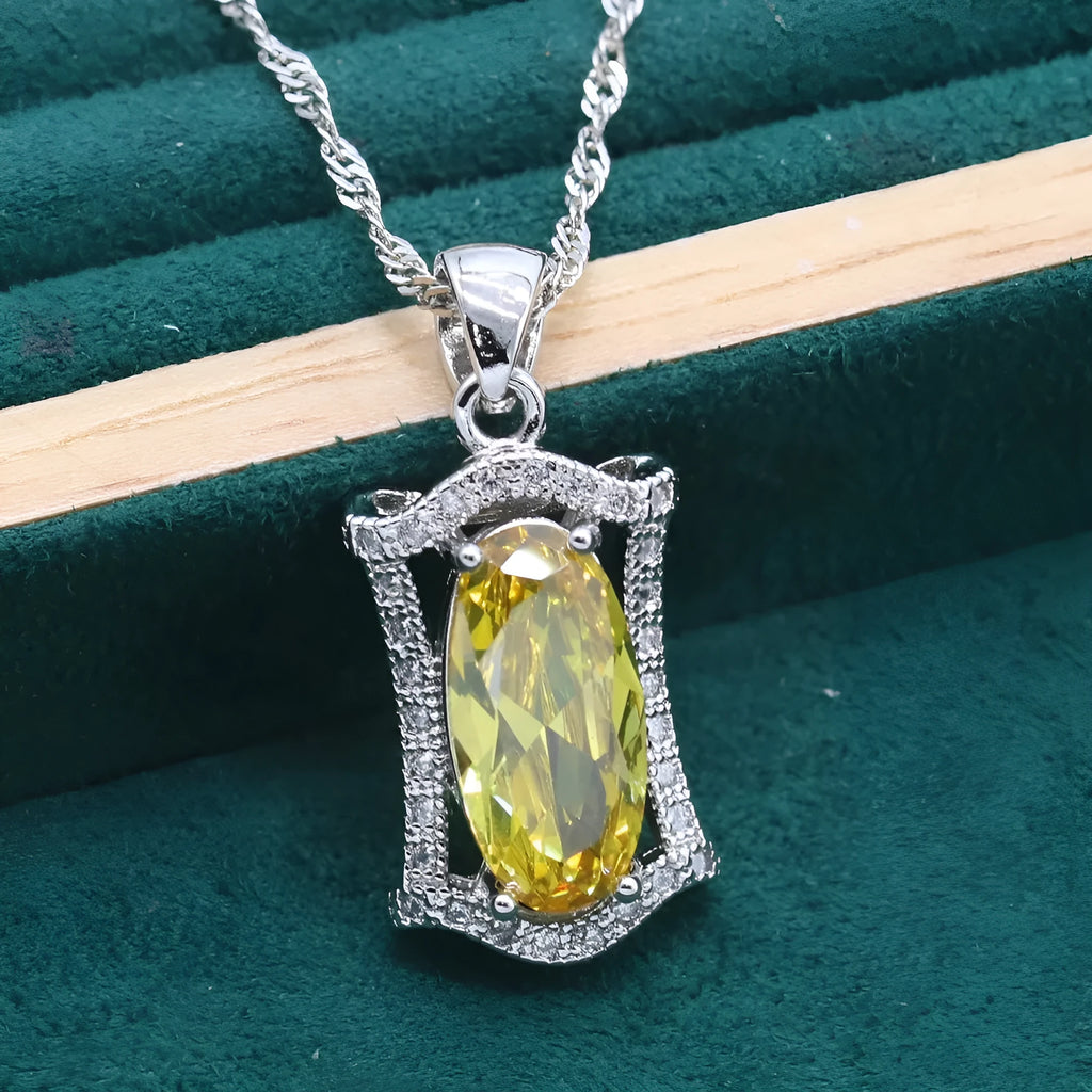 Yellow anti-allergy zircon jewellery set with snake bone chain necklace, earrings, ring, and bracelet on display.