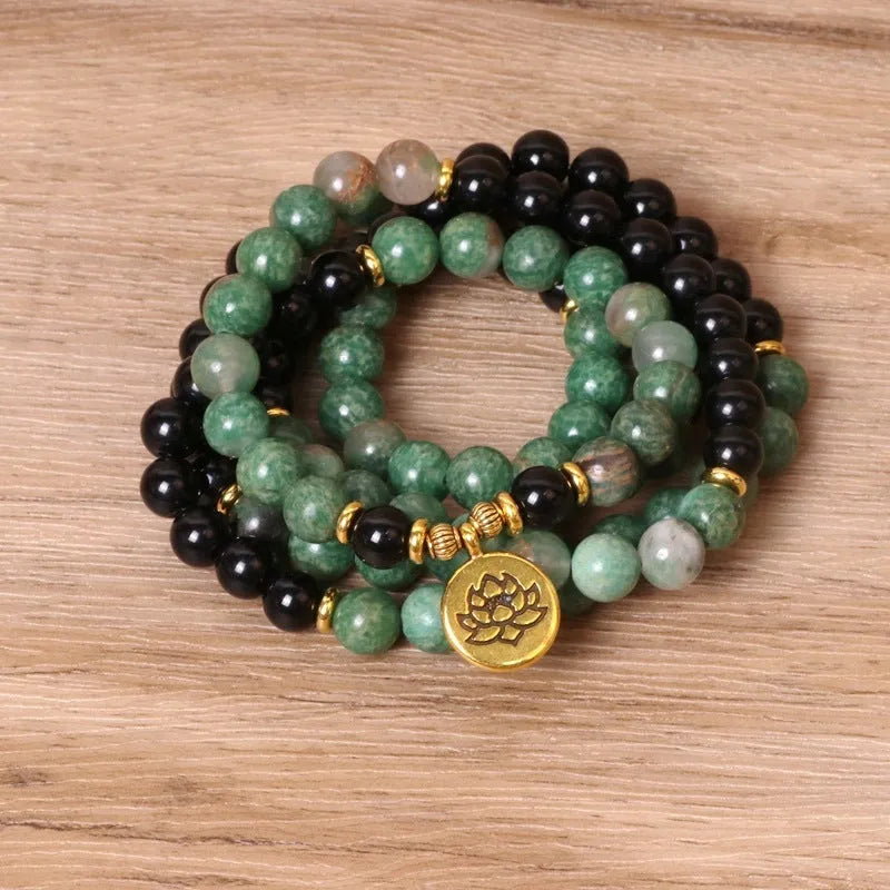 Long elastic bracelet with green and black alloy charms and natural style beads on a stretch band.