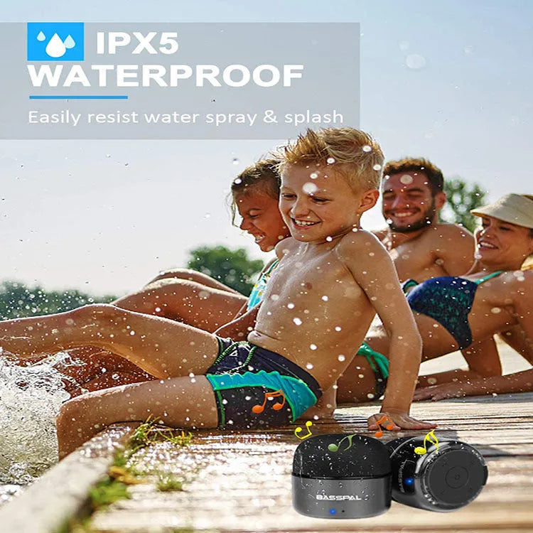 Black plastic waterproof mini Bluetooth speaker showing control buttons and USB port