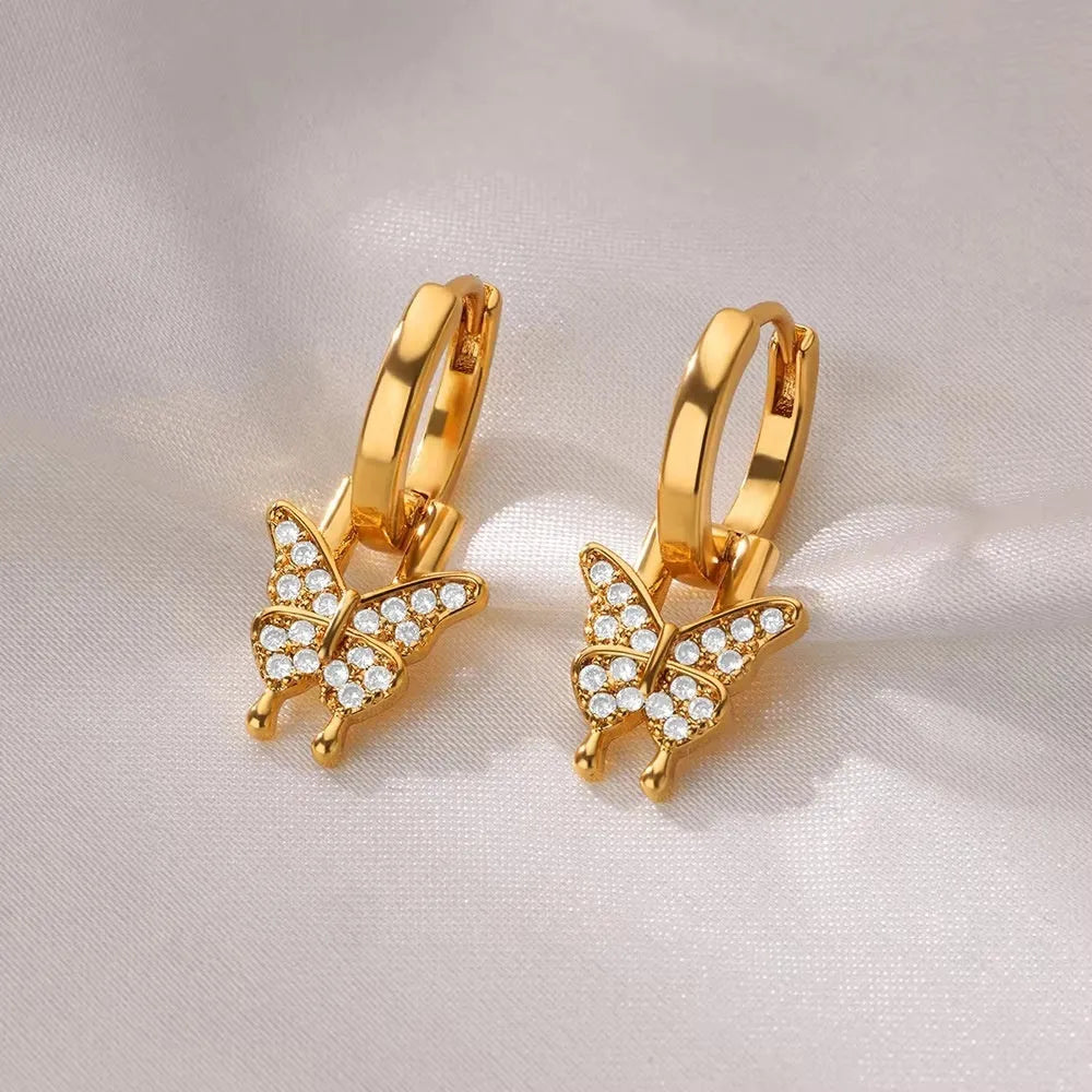 Women's copper geometric butterfly earrings with heart and star motifs in various colours.