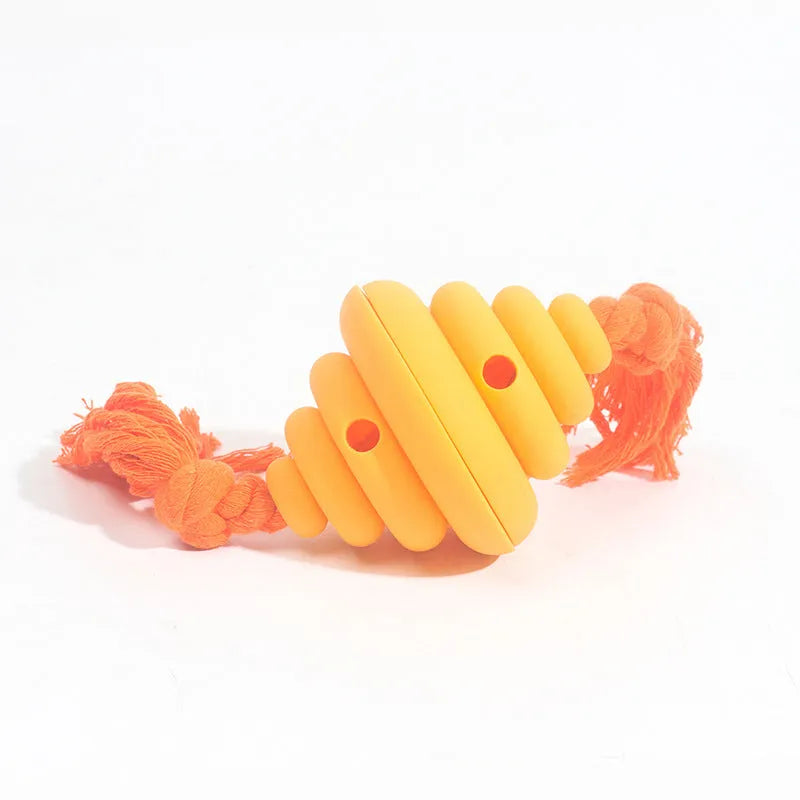 Green and yellow dog ball with integrated rope, hollow treat-dispensing design