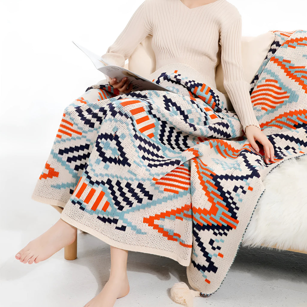 Bohemian style acrylic sofa cover blanket with tassel trim in a geometric pattern colour option.