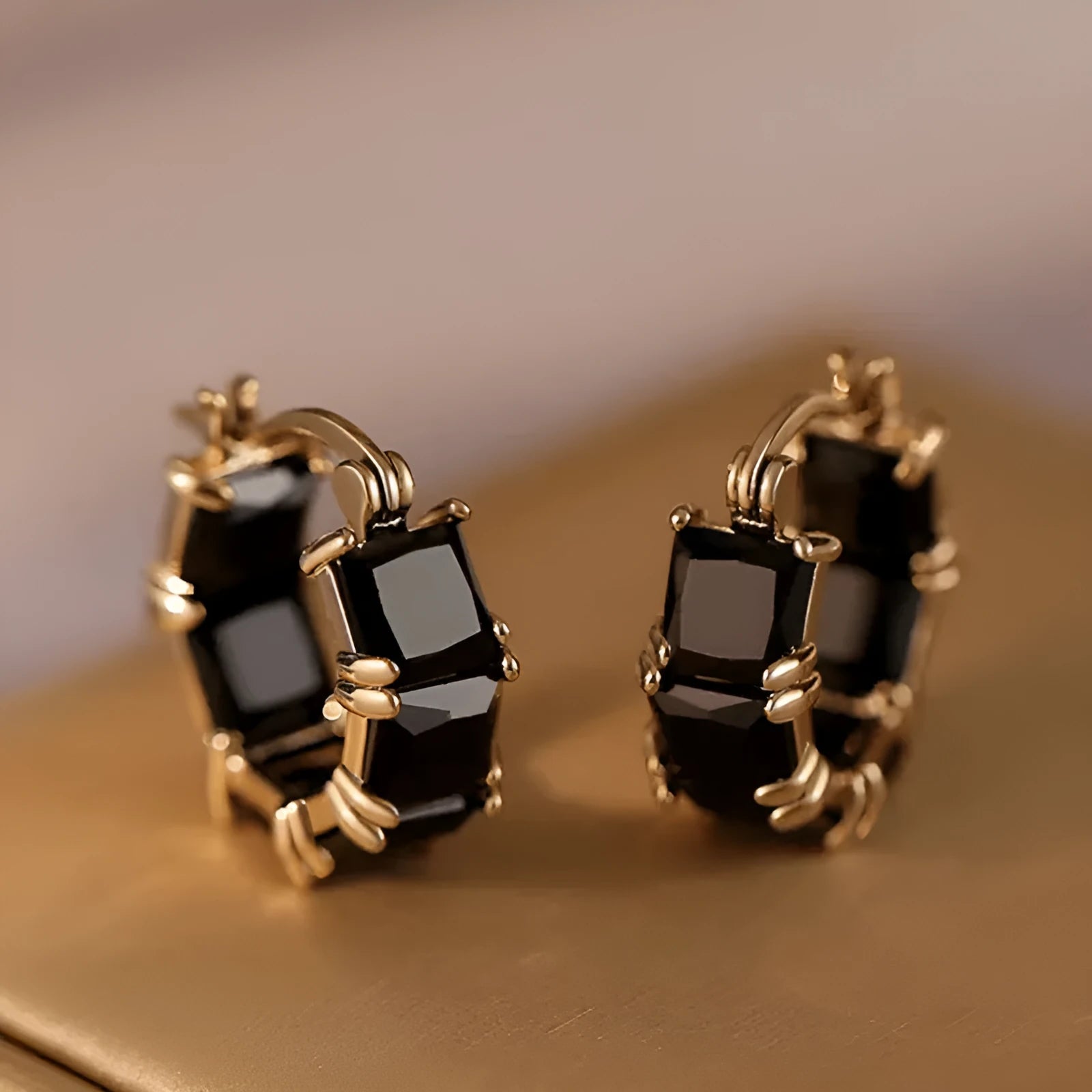 Geometric U-shaped gold earrings with black crystal zirconium stones in round design