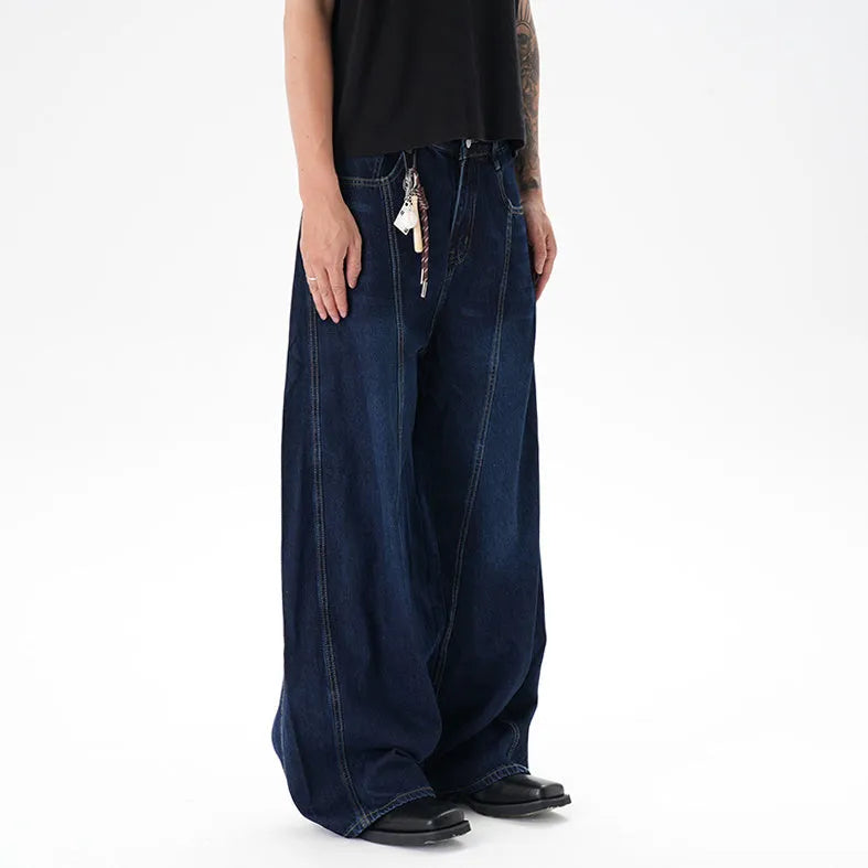 Dark blue wide-leg jeans with a distressed wash on a denim fabric, showing a relaxed fit.