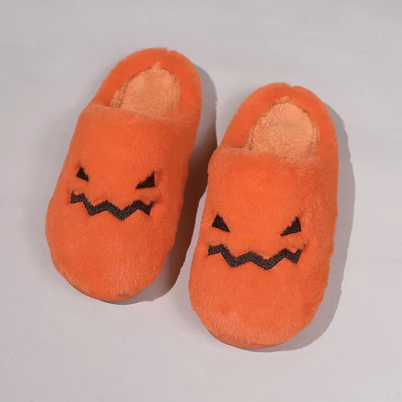 Orange Halloween pumpkin-themed plush slippers with a coral velvet upper and flat heel.