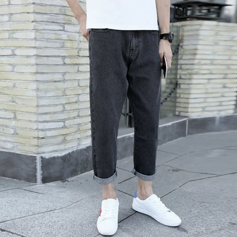 Men's black loose straight harem jeans showing casual fit and light straight leg opening