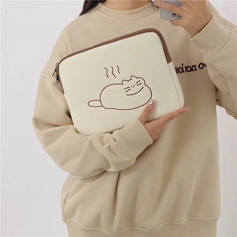 Fat cat embroidered design on a grey protective laptop sleeve with a black zip.