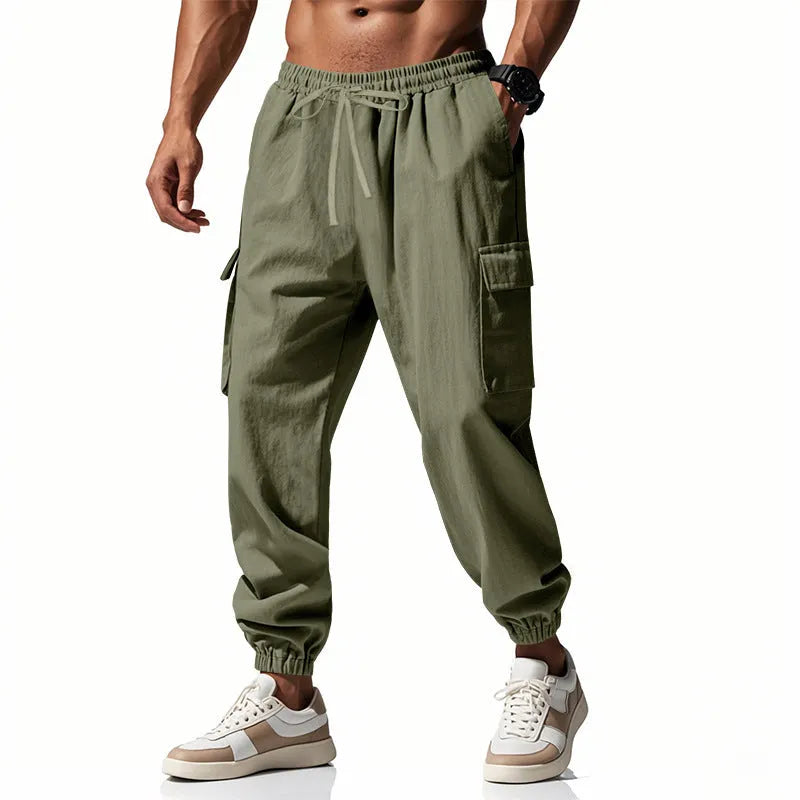 Men's loose-fit linen casual trousers with ankle ties and multiple pockets in a solid colour.