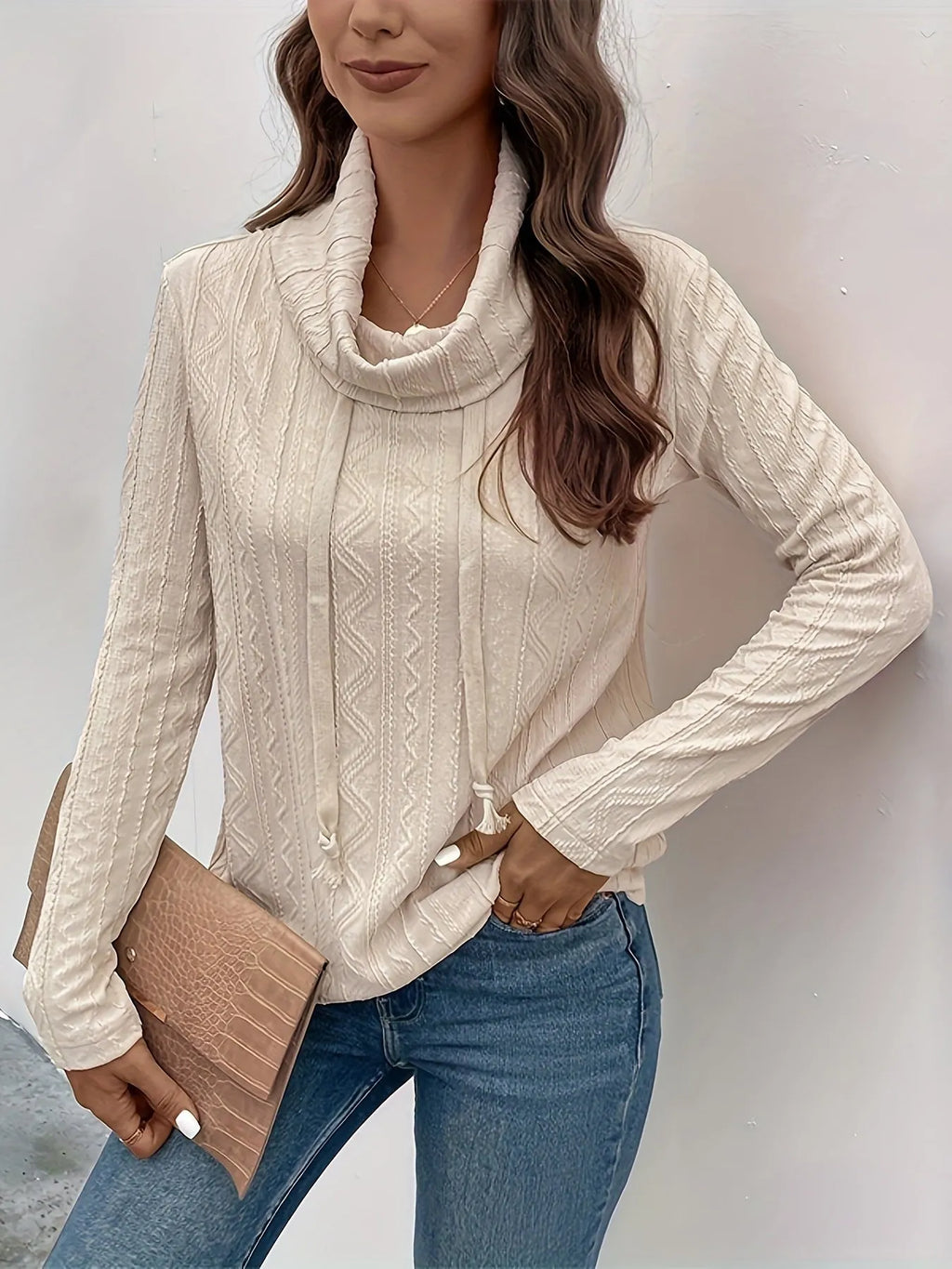Apricot coloured long sleeve hooded pullover sweater on a hanger, showing the drawstring and solid colour.