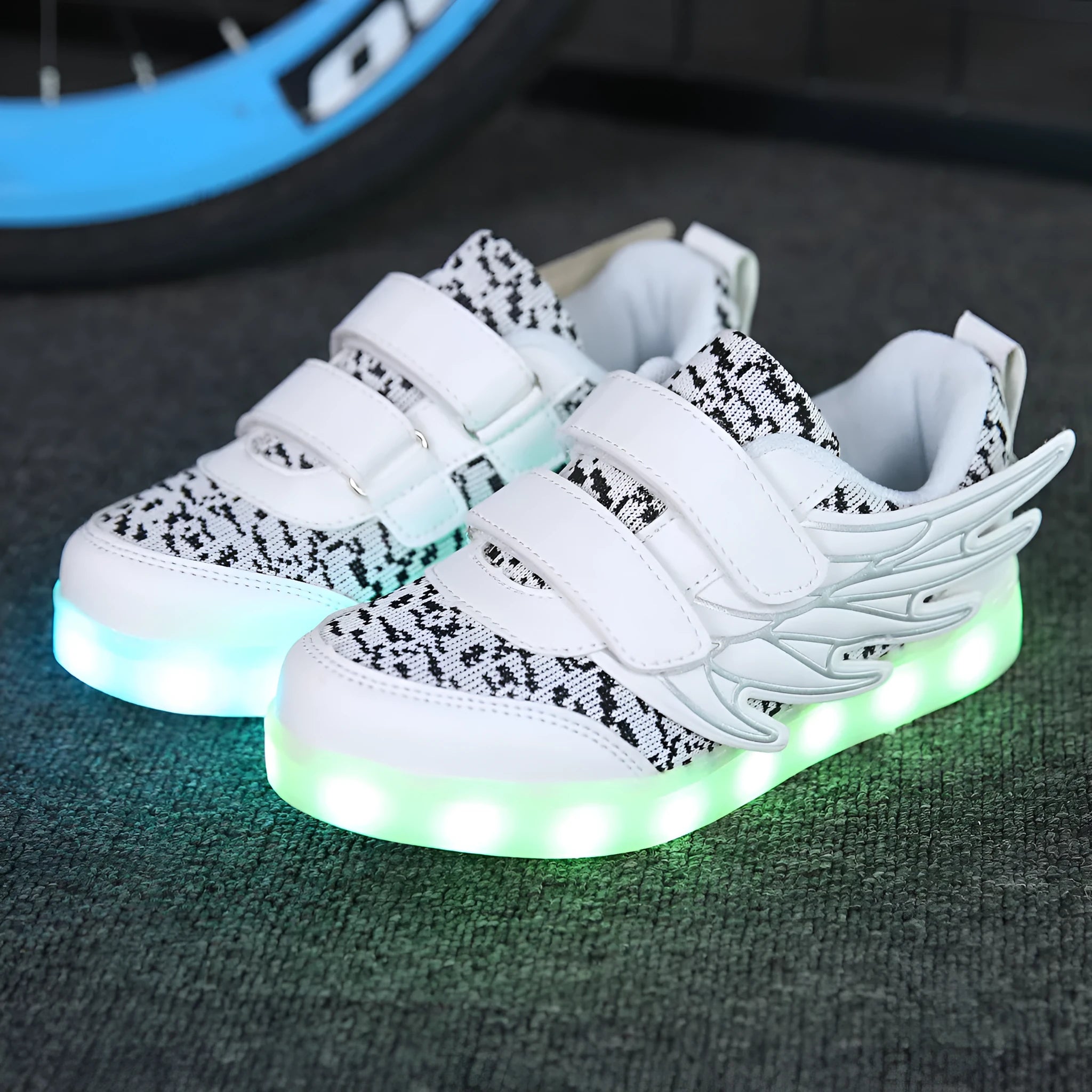 Children's plum red and white light-up sneakers with colourful luminous wings pattern and USB charging port.