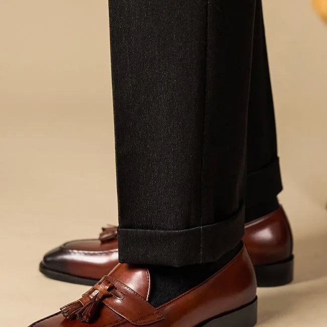 Men's black polished leather tassel loafers with rubber soles for business casual wear
