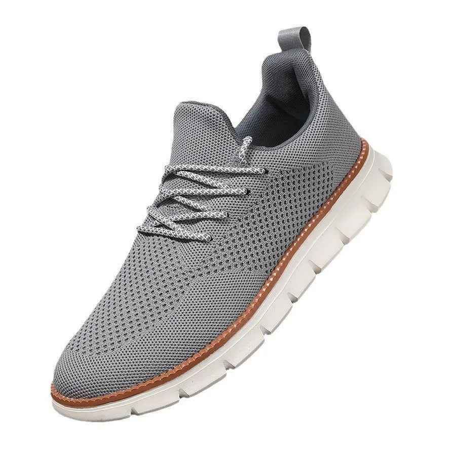 Men's grey and black low-top casual sneakers with woven mesh fabric upper and round toe.