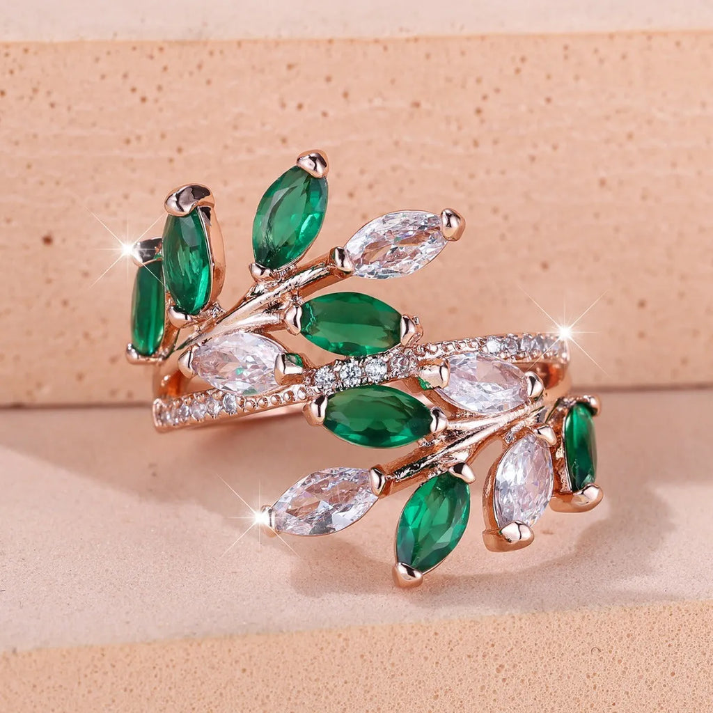 Close-up of an adjustable horse eye zircon leaf fashion ring in a rose gold finish with white stones.